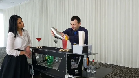 Bartender preparing cocktail for lady waiting by the mobile bar Stock Footage 72734667