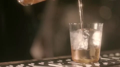 Bartender preparing a Dirty Martini in a glass at the bar Stock Footage 300863932