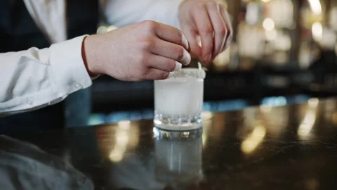 A bartender is preparing a drink in a glass Stock Footage 295996375