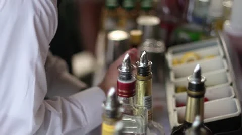 Bartender preparing drinks bottles in foreground Vídeo Stock 20467392