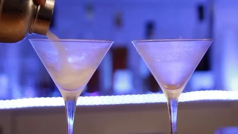 Bartender preparing gin Gibson cocktail. Woman making alcoholic cocktail with Stock Footage 71231510