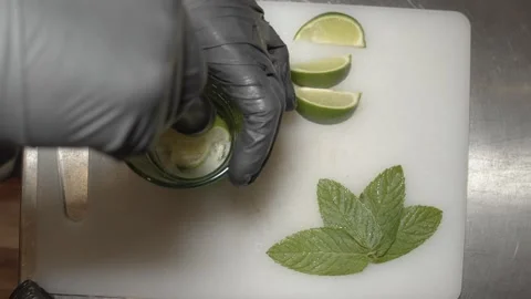 Bartender Preparing mojito cocktail with lime on ice. (D) Video stock 165464678