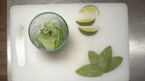 Bartender Preparing mojito cocktail with lime on ice. (E) Stock Footage 165464702