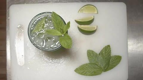 Bartender Preparing mojito cocktail with lime on ice. (A) Stock Footage 165464729