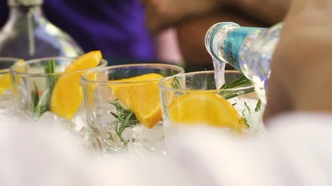 Bartender preparing, pouring refreshing drink with bubbles, ice and lime. Stock Footage 121175598