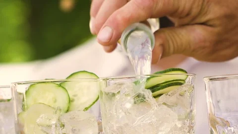 Bartender preparing, pouring refreshing drink with bubbles, ice and lime. Stock Footage 121175656