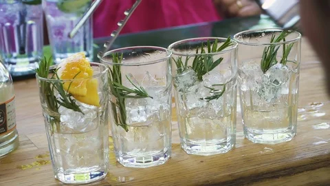 Bartender preparing, pouring refreshing drink with bubbles, ice and lime. Stock Footage 121175754