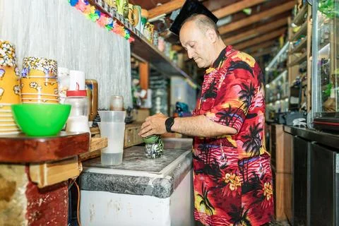 Bartender preparing tiki mug in authentic hawaiian bar Stock Photos