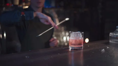 Bartender preparing traditional old fashioned cocktail with whiskey and orange Stock Footage 139114026