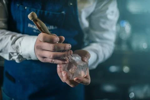 Bartender professionally working with ice to make cold good drinks Stock Photos