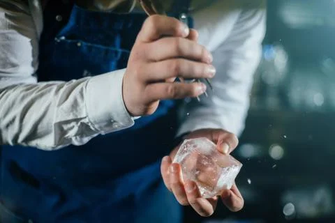 Bartender professionally working with ice to make cold good drinks Stock Photos
