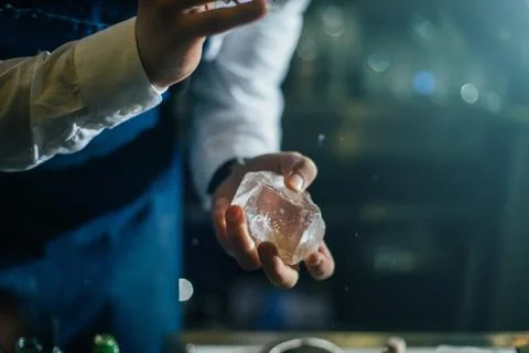 Bartender professionally working with ice to make cold good drinks Stock Photos