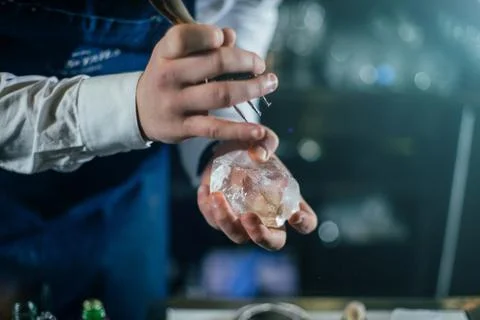 Bartender professionally working with ice to make cold good drinks Stock Photos