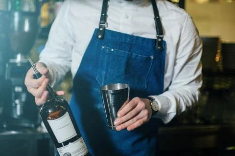 Bartender professionally working with om making drinks and cocktails Stock Photos