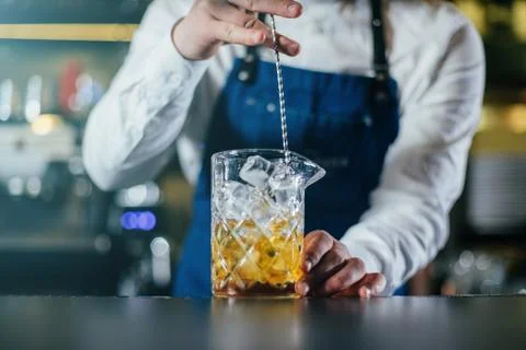 Bartender professionally working with om making drinks and cocktails Stock Photos