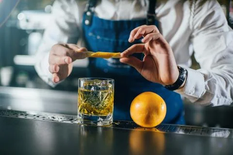 Bartender professionally working with om making drinks and cocktails Stock Photos