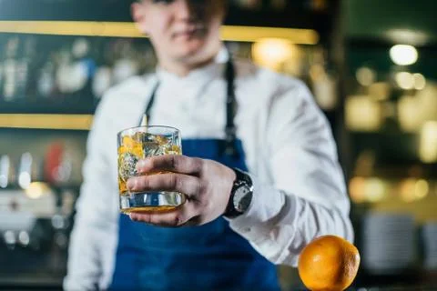 Bartender professionally working with om making drinks and cocktails Stock Photos