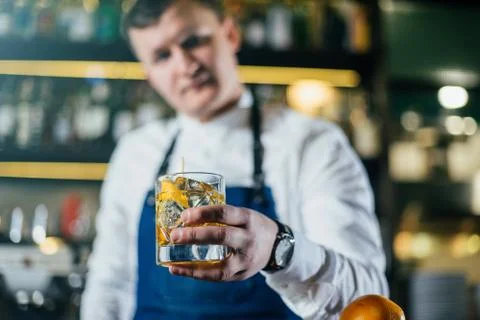 Bartender professionally working with om making drinks and cocktails Stock Photos