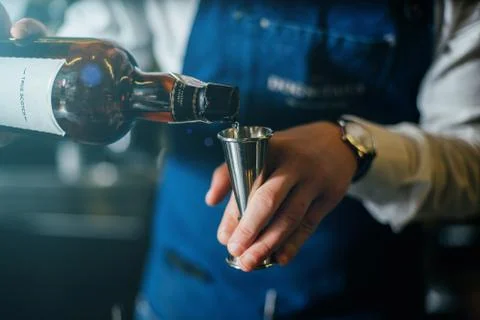 Bartender professionally working with om making drinks and cocktails Stock Photos