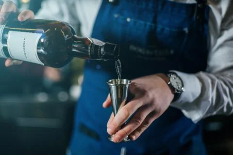 Bartender professionally working with om making drinks and cocktails Stock Photos