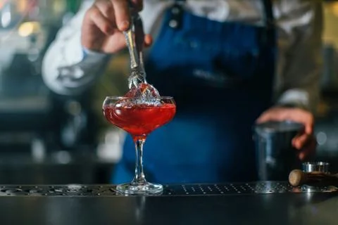 Bartender professionally working with om making drinks and cocktails Stock Photos