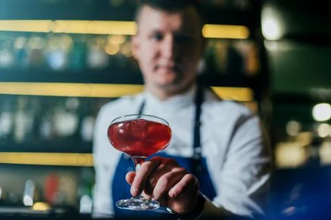 Bartender professionally working with om making drinks and cocktails Stock Photos