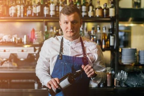 Bartender professionally working with om making drinks and cocktails Stock Photos