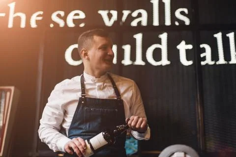 Bartender professionally working with om making drinks and cocktails Stock Photos