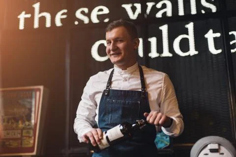 Bartender professionally working with om making drinks and cocktails Stock Photos