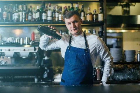 Bartender professionally working with shaker and making good drinks Stock Photos