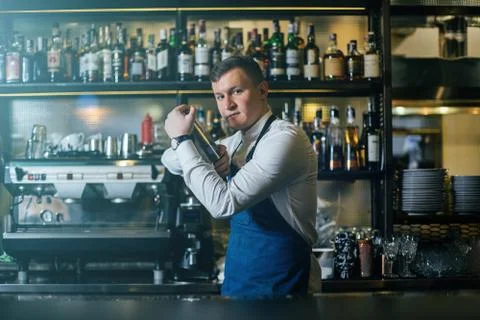 Bartender professionally working with shaker and making good drinks Stock Photos