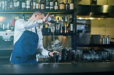 Bartender professionally working with shaker and making good drinks Stock Photos