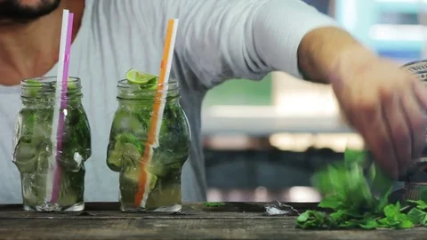 Bartender put mint in mojito cocktail Stock Footage 75441184