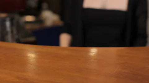 Bartender put a teapot and a cup on wooden bar counter. Medium shot 動画素材 63995095