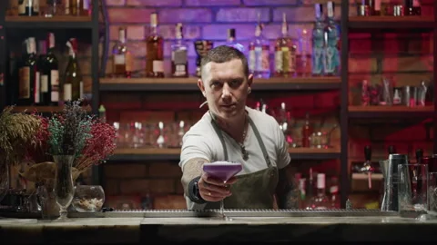 Bartender puts a beautiful ready-made cocktail on the bar stick Stock Footage 230322582