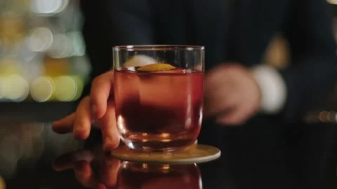 The bartender puts the finished cocktail in front of the client Stock Footage 223912358