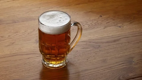 The bartender puts a glass of beer on the table Stock Footage 242789521