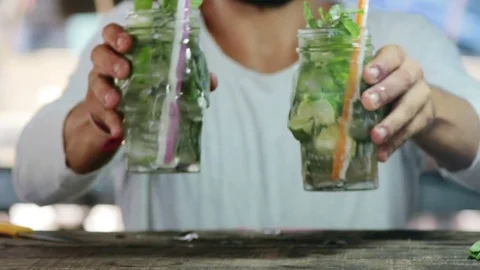 Bartender puts glasses with mojito on the foreground Stock Footage 75435711