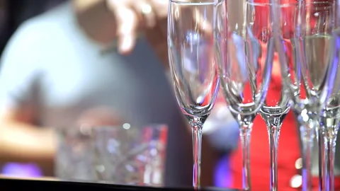 Bartender puts ice cubes in drinks Stock Footage 244984917