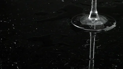 The bartender puts ice cubes on a glossy black table. Stock Footage 100638048