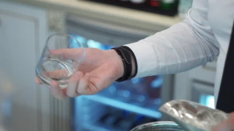 Bartender puts ice in the rocks Stock Footage 101968345