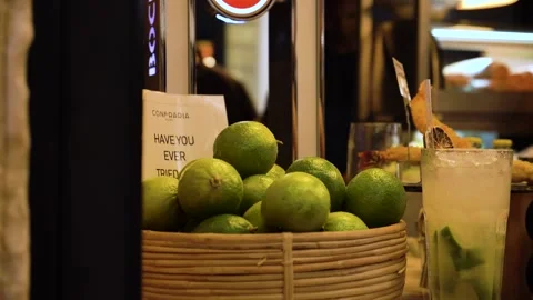 Bartender puts limes in a wicker basket to prepare a fresh cold mojito  Stock Footage 156512230