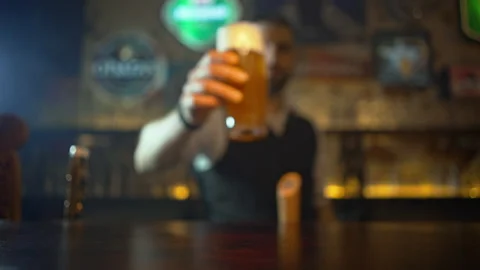 The bartender puts a pint of beer on the table. Stock Footage 155827753