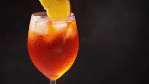 Bartender puts a slice of orange in a cocktail. Cocktail aperol spritz Stock Footage 159356157