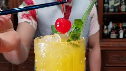 Bartender putting a cherry on a tiki cocktail. Stock Footage 154617197