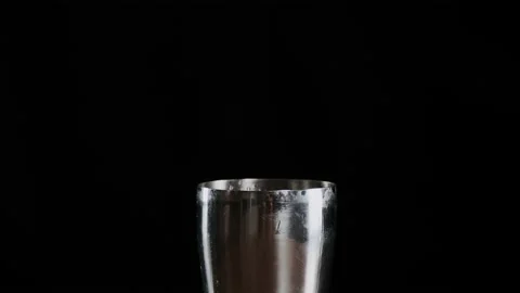 Bartender putting crystal ice cubes in shaker while preparing alcoholic cocktail Stock Footage 132765842