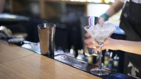Bartender putting ice into a shaker and adding juice Stock Footage 79359675