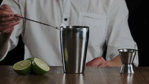 Bartender putting sugar powder in shaker while preparing alcoholic cocktail Stock Footage 132772283