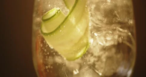 Bartender Removing Cucumber Garnish from Iced Cocktail in Macro Close Up Stock-Footage 347897383