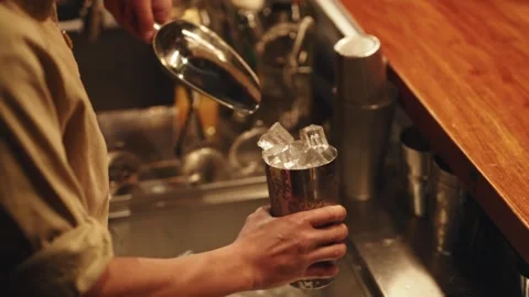 Bartender Scooping Fresh Ice Cubes into Metal Cocktail Shaker Stock Footage 331204076